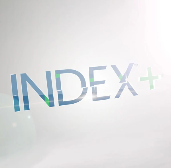 Index+ wordmark logo rendered in glossy blue and green glass-like letters on a light white gradient background