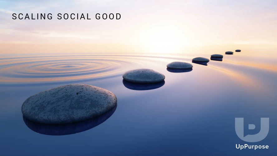 Row of stepping stones receding across calm water toward a sunrise, headline "SCALING SOCIAL GOOD"
