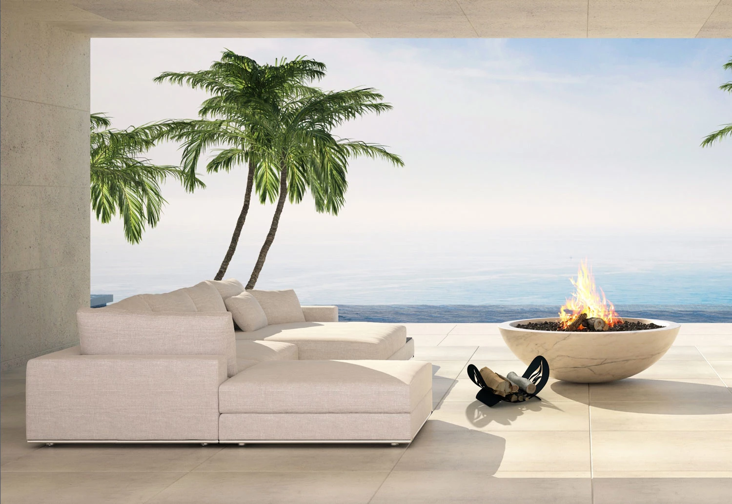 Beige sectional sofa and round stone fire bowl on a terrace with palm trees and ocean view, outdoor lifestyle photo