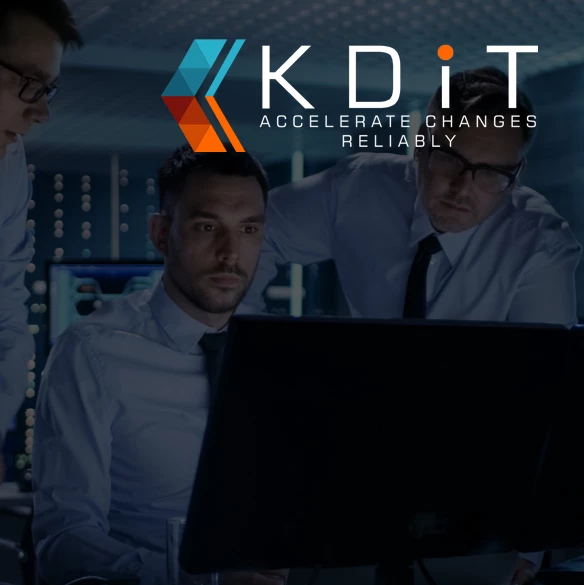 Three men in business shirts and ties working at a dark monitor in a server-room style office