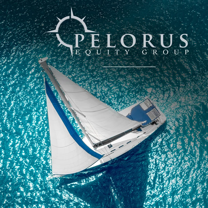 Aerial view of a white sailboat with blue hull stripe on turquoise water
