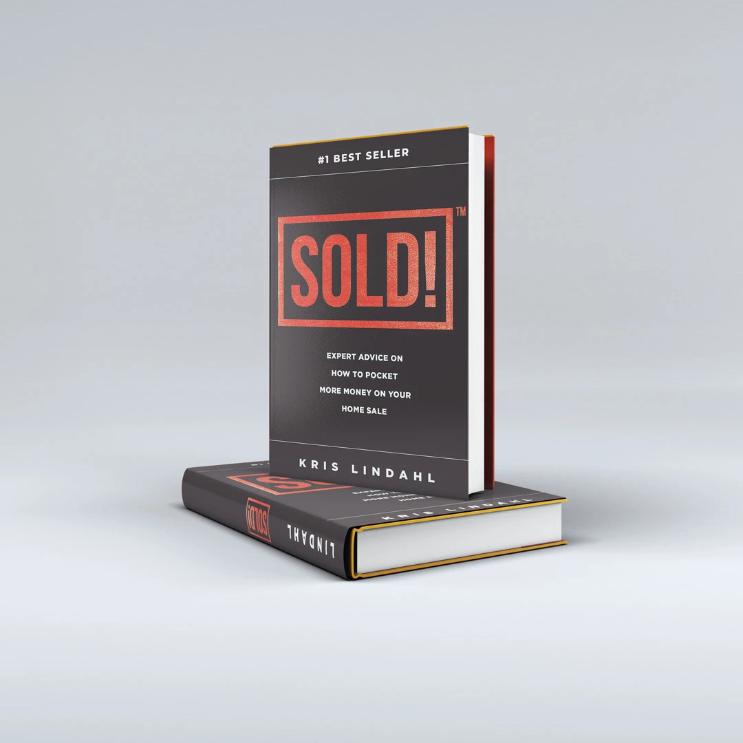 Hardcover book mockup for SOLD! by Kris Lindahl, one upright and one lying flat on a light gray studio backdrop