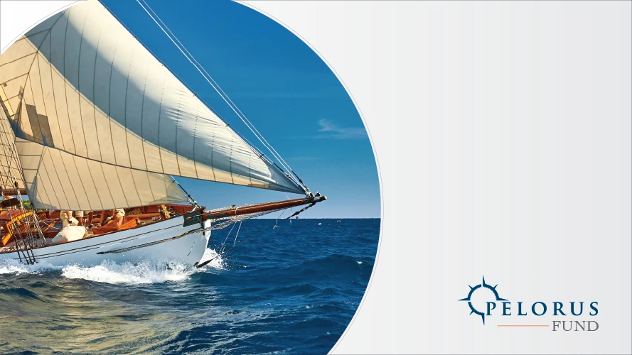 Classic wooden sailing yacht cutting through blue ocean under cream sails