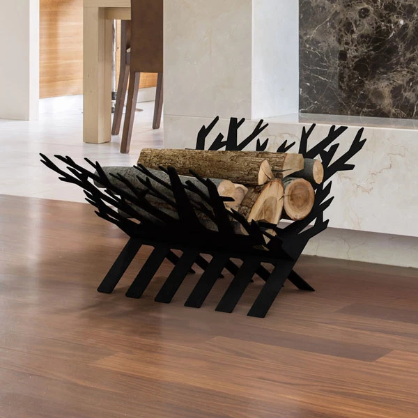 Black metal branch-design firewood rack holding split logs on a hardwood floor in a modern interior